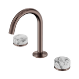 An image of Nero Tapware's Serenity Basin Set Arc Spout With Arabescato Corchia Handle Brushed Bronze