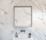 Bathroom with marble wall, sink, and mirror